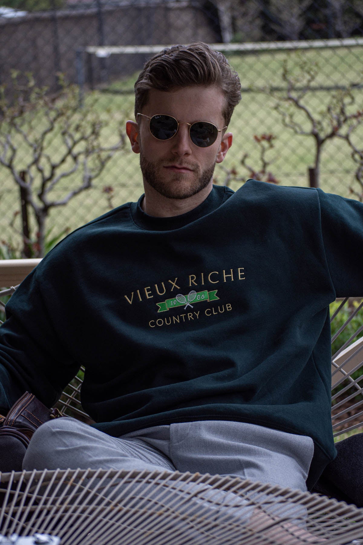 Man in sunglasses wearing Pine Green Vintage Country Club Crew, embodying classic old money fashion.